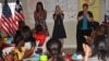 U.S. first lady Michelle Obama (L) is welcomed by Peace Corp teachers and students at a project 70 kilometers (43 miles) from the capital city Monrovia in Kakata, Liberia, June 27, 2016. 