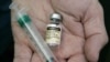 FILE - A doctor holds a vial of the human papillomavirus (HPV) vaccine Gardasil in his Chicago office. 