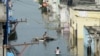 Flood-affected residents search for their belongings following heavy rains on the outskirts of Hyderabad, India.