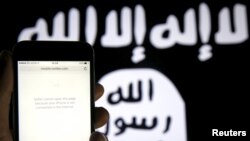 FILE - An unloaded Twitter website is seen on a phone without an internet connection, in front of a displayed ISIS flag in this photo illustration in Zenica, Bosnia and Herzegovina.