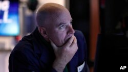 Specialist John O'Hara works at his post on the floor of the New York Stock Exchange, March 12, 2020.