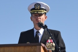 FILE - Captain Brett Crozier addresses the crew for the first time as commanding officer of the aircraft carrier USS Theodore Roosevelt in San Diego, California, March 1, 2020.