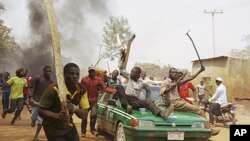 Demonstrators protest against the elimination of a popular fuel subsidy that has doubled the price of petrol in Nigeria's captial Abuja, January 10, 2012.