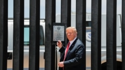 U.S. President Donald Trump prepares to autograph a plaque commemorating the construction of the 200th mile of border wall while visiting the wall on the U.S.-Mexico border in San Luis, Arizona, June 23, 2020.