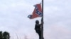 Bree Newsome of Charlotte, N.C., climbs a flagpole to remove the Confederate battle flag at a Confederate monument in front of the Statehouse in Columbia, S.C., June, 27, 2015. 