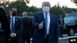 US President Donald Trump gives the thumbs-up as he leaves Walter Reed Medical Center