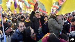 Pro-Kurdish demonstrators protest against Turkish President Recep Tayyip Erdogan and the political repression that followed July's failed military coup, in Cologne, Germany, Nov. 12, 2016.