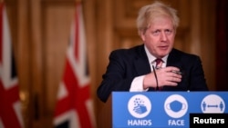 Britain's Prime Minister Boris Johnson speaks during a news conference in response to the ongoing situation with the coronavirus disease (COVID-19) pandemic, inside 10 Downing Street, London ,Britain, Dec. 19, 2020.