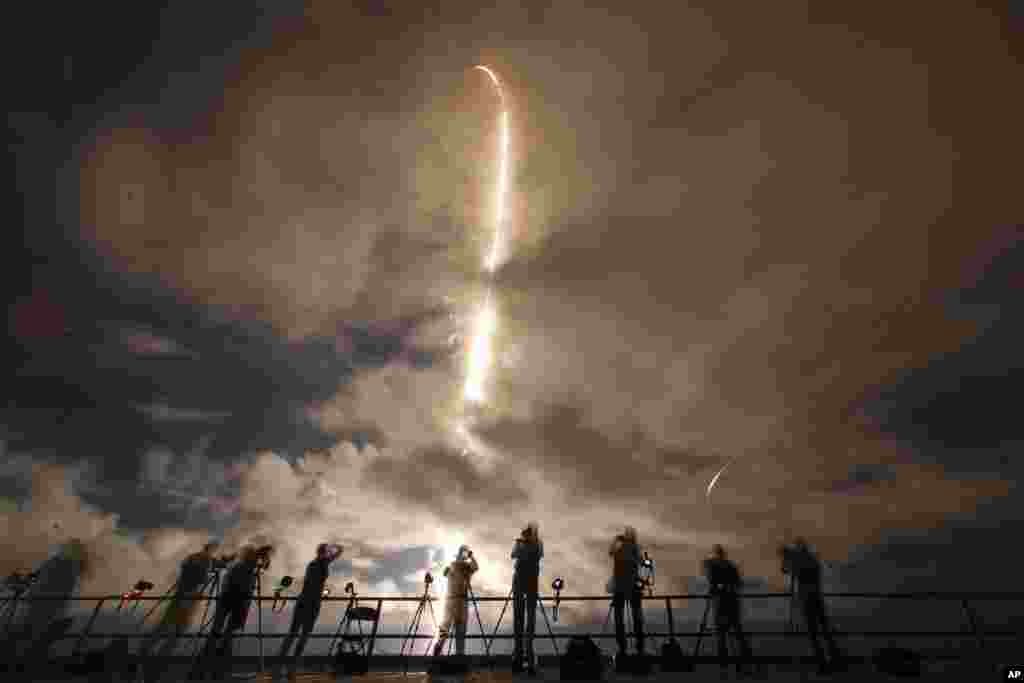 A time exposure shows photographers as they document the SpaceX Falcon 9 rocket with a crew of four as it launches from pad 39A at the Kennedy Space Center in Cape Canaveral, Florida, Sept. 9, 2024.
