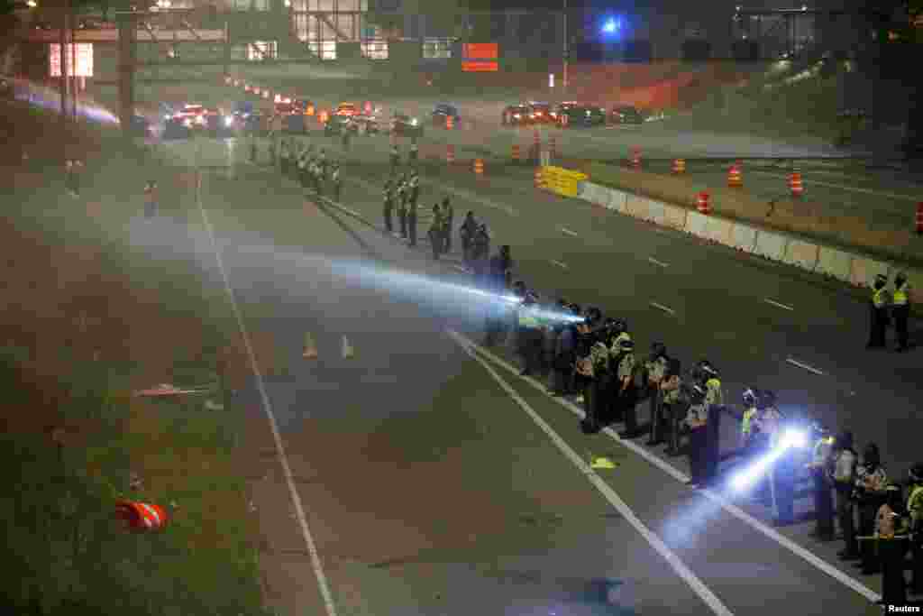 Police are seen as people gather on Interstate 94 to protest the fatal shooting of Philando Castile by Minneapolis area police during a traffic stop in St. Paul, Minnesota, July 9, 2016.