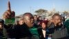 Mineworkers dance as they gather for check-ins near Lonmin's Marikana platinum mine before returning to work, June 25, 2014. 