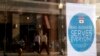 A sign reading "This business serves everyone" is displayed in the window of Bernadette's Barbershop in Lafayette, Indiana, in the wake of the passage of the state's Religious Freedom Restoration Act, March 31, 2015.