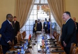 U.S. Secretary of State Mike Pompeo, right, meets with Angola Foreign Minister Manuel Domingos Augusto before a press conference at the Ministry of Foreign Affairs in Luanda, Angola, Feb. 17, 2020.
