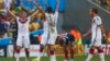 German soccer players celebrate win as France's Antoine Griezmann reacts after the final whistle is blown at 2014 World Cup quarter-finals, Maracana stadium, Rio de Janeiro, July 4, 2014.