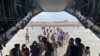 In this photo provided by the Spanish Defence Ministry, people board a Spanish air force A400 plane as part of an evacuation plan at Kabul airport in Afghanistan, Aug.18, 2021. 
