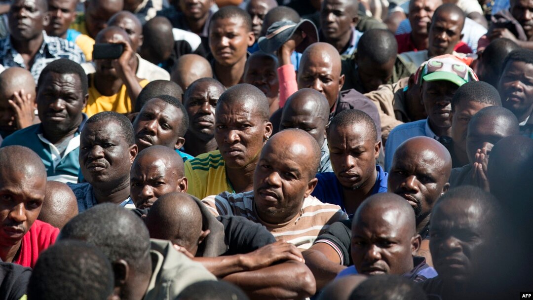 Striking miners gather gathered at the Wonderkop Stadium in Marikana as they wait for Association of Mine workers and construction Union's president Joseph Mathunjwa to address them on May 14, 2014 in Marikana, South Africa.