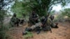 A soldier serving with the African Union Mission in Somalia takes up a defensive position in a fire fight during their joint AMISOM and Somali National Army (SNA) operation to seize and liberate territory from al-Shabab militants in Deyniile, Somalia, May