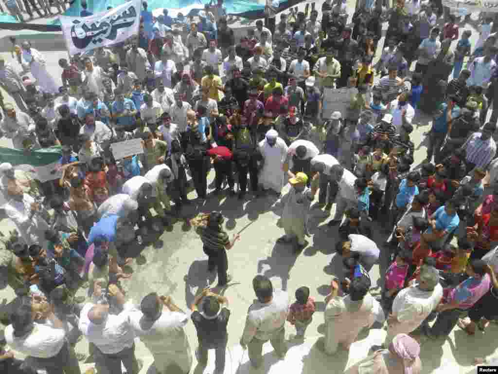Demonstrators protest Syria's President Bashar Al-Assad at Sermeen, near Idlib, Syria, July 27, 2012.