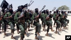 FILE - Hundreds of al-Shabab fighters perform military exercises in the Lafofe area 18 kilometers south of Mogadishu, Somalia, Feb. 17, 2017. 