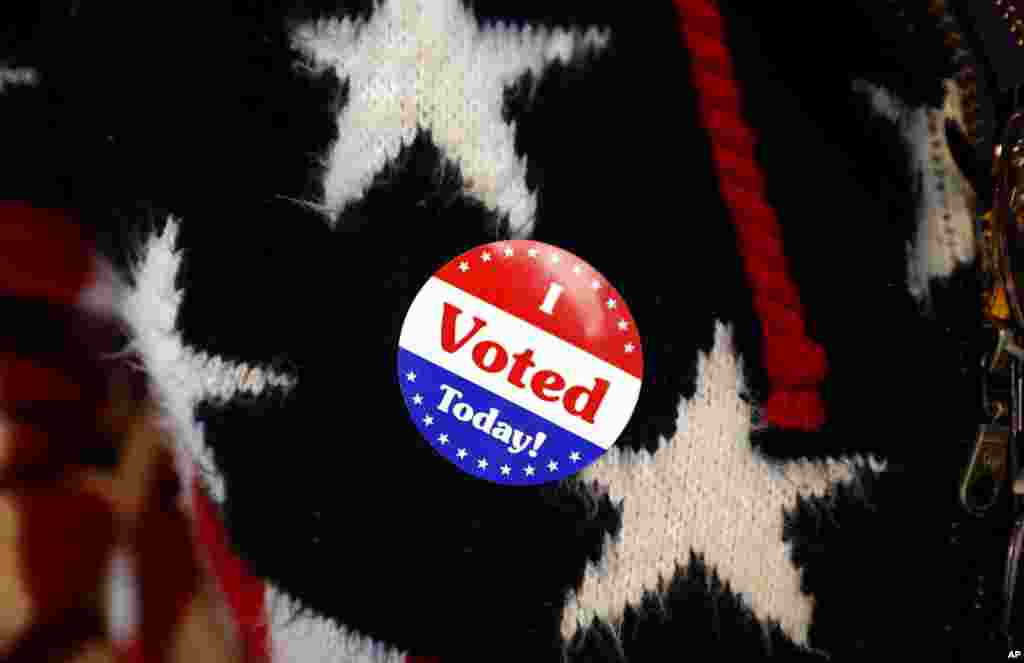 Maria Morahn, of Osceola, Iowa, wears a sticker after casting her ballot in the general election, Nov. 6, 2018, at the United Methodist Church in Osceola, Iowa.