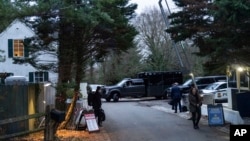 FILE - The access road to President Joe Biden's home in Wilmington, Del., is seen from a media van on Jan. 13, 2023. A special counsel's report listed dozens of sensitive documents found at Biden's home and at his former Washington office.