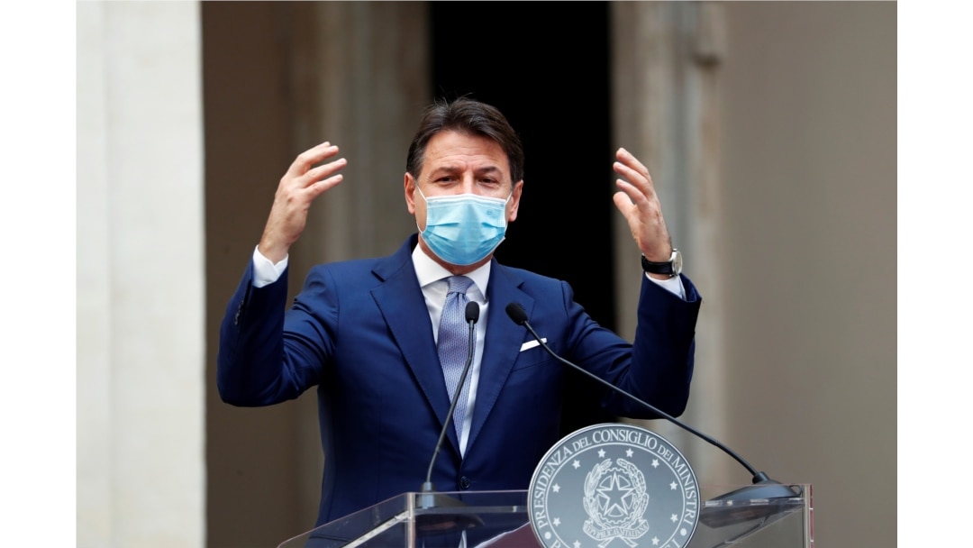 Italian Prime Minister Giuseppe Conte wearing a protective face mask gestures as he speaks during a news conference on government's new anti-COVID-19 measures, at Chigi Palace in Rome, Oct. 25, 2020.