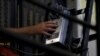 FILE - A death row inmate uses a phone from his cell in at San Quentin State Prison in San Quentin, Calif. Dec. 29, 2015. 