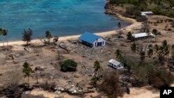 FILE - In this photo provided by the Australian Defence Force, debris from damaged building and trees are strewn around on Atata Island in Tonga, on Jan. 28, 2022, following the eruption of an underwater volcano and subsequent tsunami. 