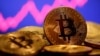 FILE - A representation of virtual currency bitcoin is seen in front of a stock graph in this illustration taken Jan. 8, 2021.