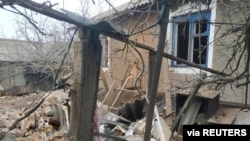A residential building, which according to Ukraine's local officials was damaged by shelling, is seen in the town of Vrubivka, in the Luhansk region, Ukraine, in this handout picture released Feb. 17, 2022.