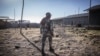 FILE - A police officer walks inside a prison in Mehal Meda, Ethiopia, Dec. 06, 2021. Thousands of Ethiopian civilians reportedly remain detained under an emergency law, without due process.