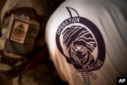 FILE - French Barkhane force soldiers who wrapped up a four-month tour of duty in the Sahel leave their base in Gao, Mali, June 9, 2021.