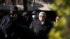 Golden Dawn party leader Nikos Michaloliakos, center, leaves his residence in Athens, Greece, Oct. 22, 2020.