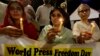 FILE - Pakistani journalists attend a candlelight vigil to observe the World Press Freedom Day, which was declared by the UN General Assembly in 1993, May 3, 2019, in Karachi, Pakistan. 