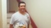 Shown standing at the entrance to his apartment, Guillermo Peralta was arrested by immigration agents on his way to work last February.