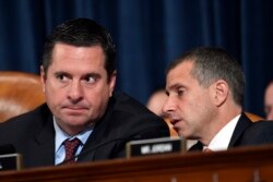 Republican Congressman Devin Nunes, left, talks to Steve Castor, Republican staff attorney, during testimony from former U.S. Ambassador to Ukraine Marie Yovanovitch on Capitol Hill in Washington, Nov. 15, 2019.