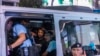 Aktivis Leo Tang ditangkap polisi di dekat Taman Victoria, lokasi peringatan tahunan pembantaian Tiananmen 1989, di Hong Kong, Minggu, 4 Juni 2023. (AP/Louise Delmotte)