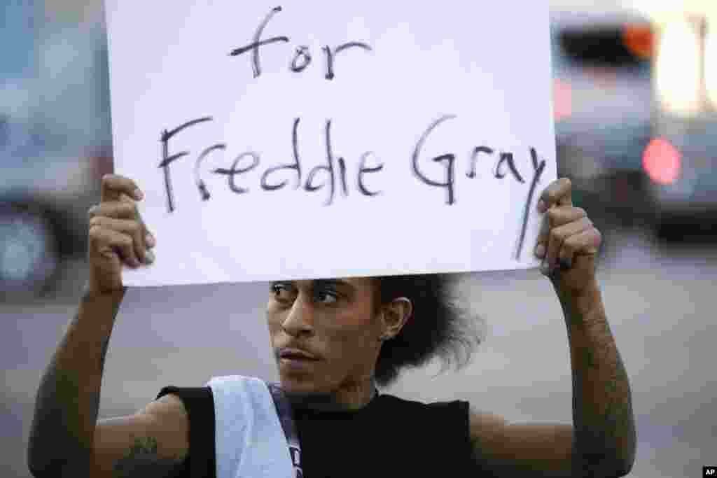 Lee Martel, 27, holds a sign during a protest following the funeral of Freddie Gray, who died from spinal injuries while in police custody, in Los Angeles, April 28, 2015.