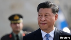 Chinese President Xi Jinping reviews guards of honor during a wreath laying ceremony at the Tomb of the Unknown Soldier in Athens, Greece, November 11, 2019. 