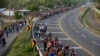 Central American migrants, part of the caravan hoping to reach the U.S. border, walk in Frontera Hidalgo, Mexico, April 12, 2019.