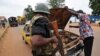 A gendarme checks a car at a checkpoint in the PK4 district of Bangui, Feb. 27, 2014. 