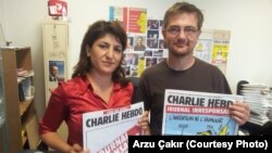 FILE - Stephane Charbonnier, right, editor-in-chief of the French publication Charlie Hebdo, was interviewed in 2012 by VOA's Arzu Çakır. Charbonnier was killed in an attack that left at least 12 people dead, in Paris, France, Jan. 7, 2015.