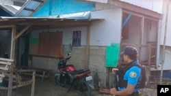 In this photo provided by the Philippine National Police Regional Office 9, a policeman checks an area Oct. 18, 2024, Elliot Onil Eastman was reportedly abducted by gunmen in Sibuco town, Zamboanga del Norte province, southern Philippines. 