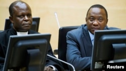 FILE - Kenya's President Uhuru Kenyatta (R) and a member of the Defense Council attend a hearing at the International Criminal Court in The Hague, Netherlands, Sept. 21, 2011.
