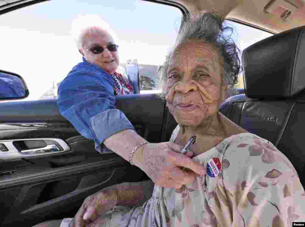Grace Bell Hardison, de 100 anos de idade, recebe um autocolante "Votei Hoje" depois de votar a partir do seu carro em Belhaven, no estado da Carolina do Norte.