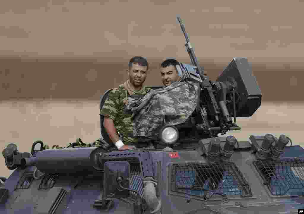 Turkish soldiers patrol on the outskirts of Suruc during fighting in Kobani between Syrian Kurds and the militants of Islamic State group, Oct. 16, 2014.