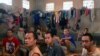 Prisoners sit on a bench inside the Sialang Bungkuk jail in Pekanbaru, on Indonesia's Sumatra island, May 7, 2017. (Antara Foto/Priyatno via Reuters)