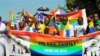People who identified themselves as members of the lesbian, gay, bisexual and transgender (LGBT) community parade in Entebbe, southwest of Uganda's capital, Kampala, Aug. 8, 2015. 