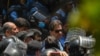 FILE - Police escort Pakistan's former Prime Minister Imran Khan upon his arrival at the high court in Islamabad on May 12, 2023.