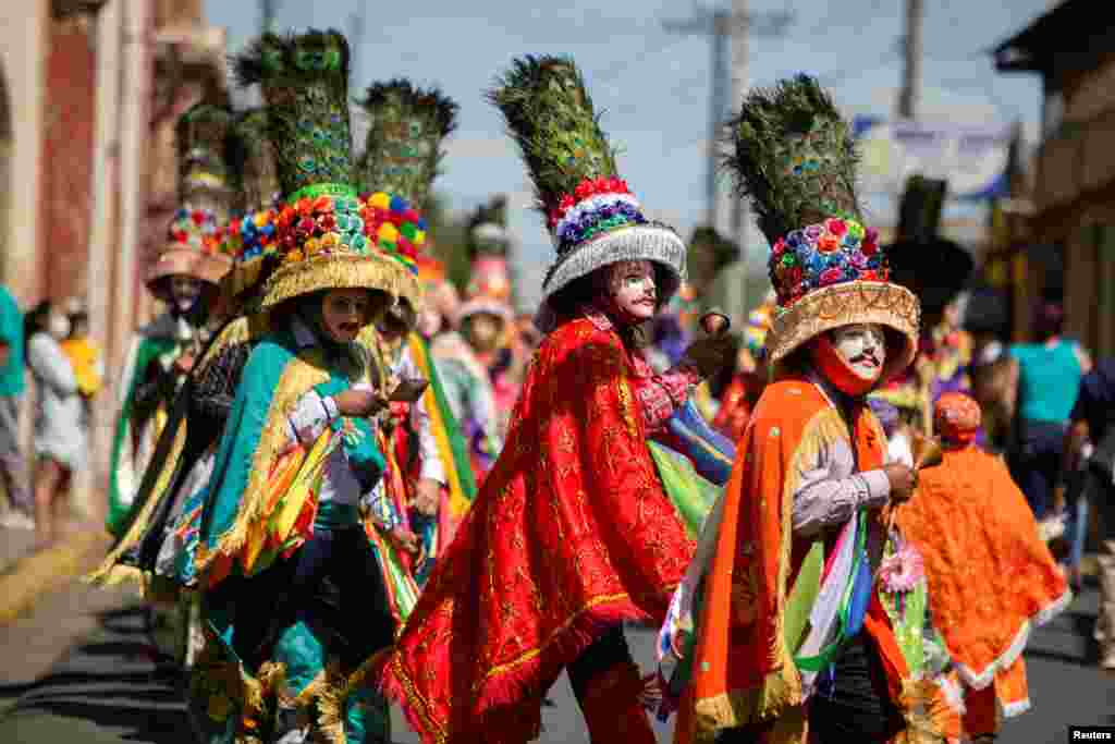 Parishioners take part in El Gueguense, a satyrical drama and an expression of protest against the colonial rule to mark the Feast of Saint Sebastian, in Diriamba, Nicaragua, Jan. 19, 2022.